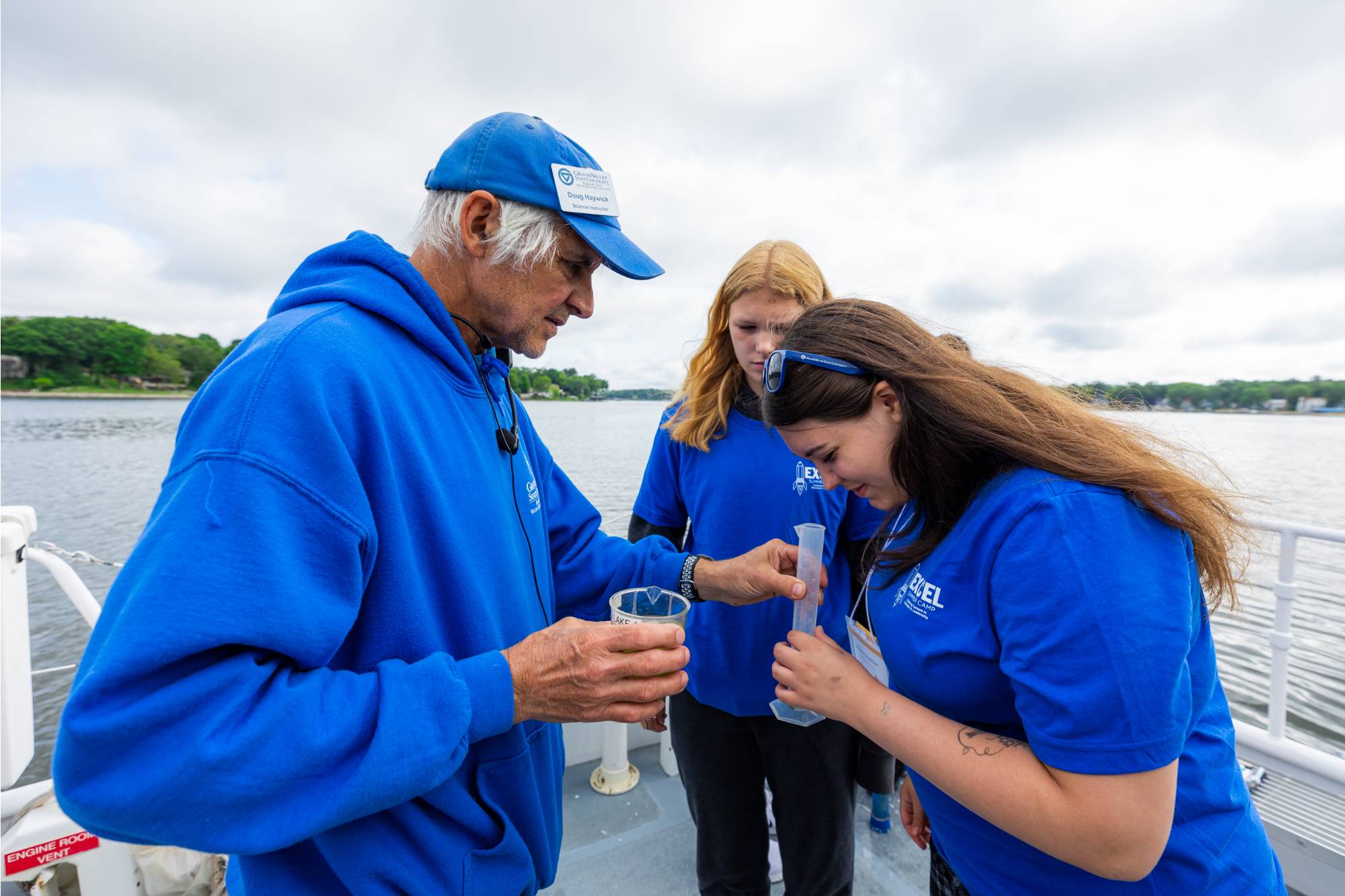 Student scientists looking at a water sample on the D.J. Angus